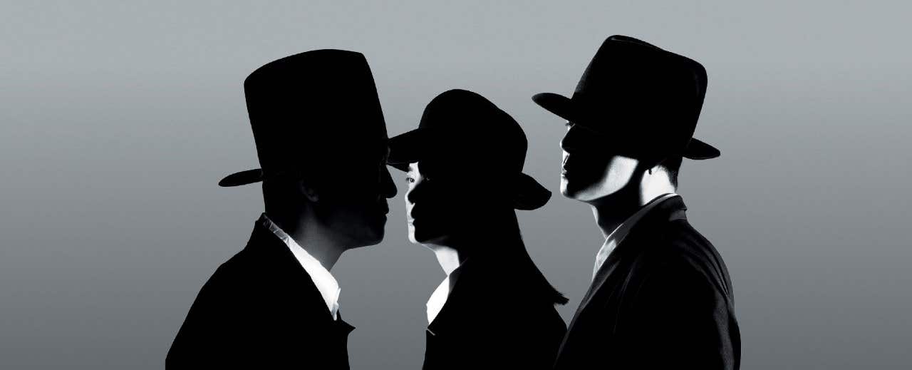 Silhouettes of three people wearing hats, facing different directions against a gradient background.