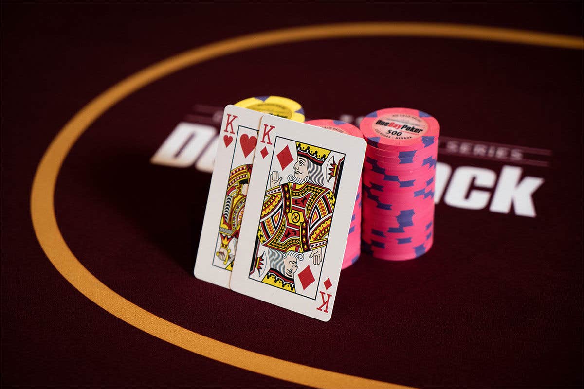 Two queen cards resting on a stack of poker chips.