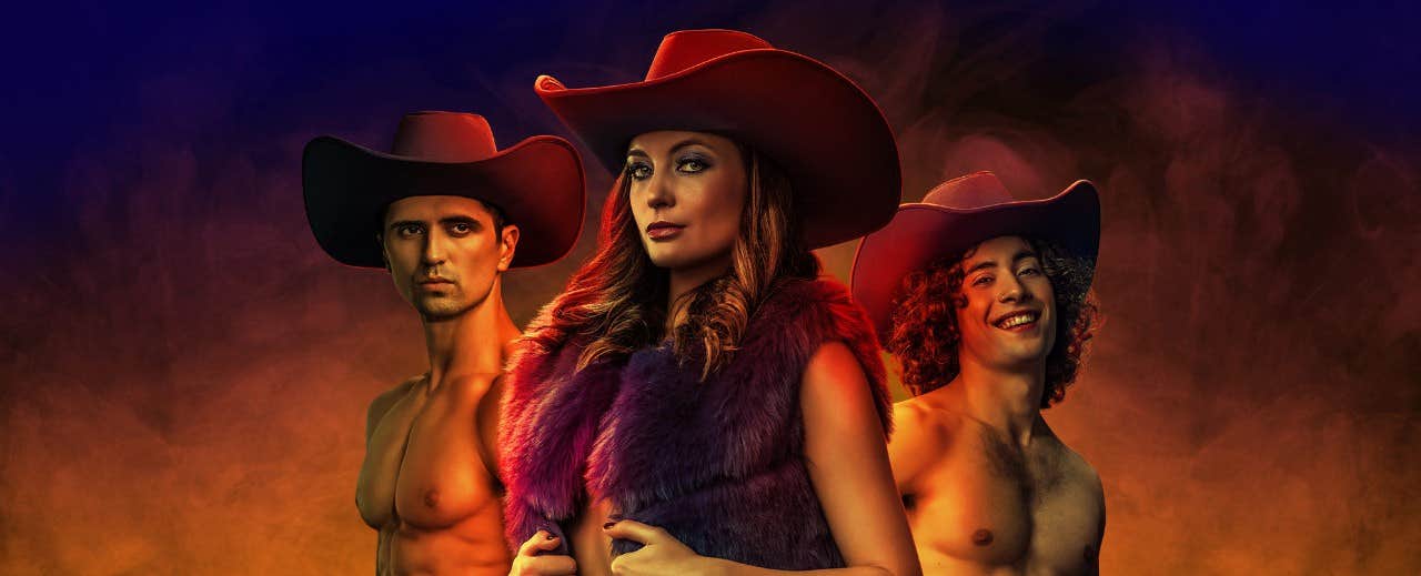 Three individuals wearing cowboy hats, two shirtless men and a woman in a fur vest, posed against a smoky background.