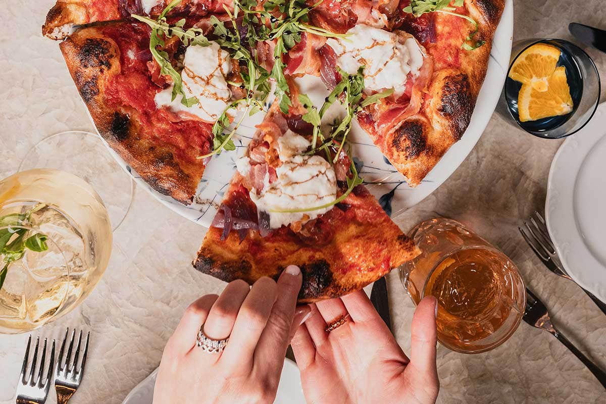 Burrata Pizza with drinks on the side at LAVO Italian Restaurant Las Vegas.