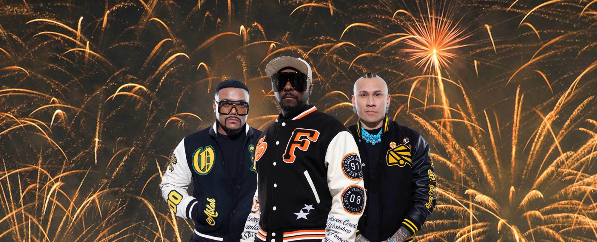 Three individuals wearing varsity jackets stand in front of a background of vibrant fireworks.