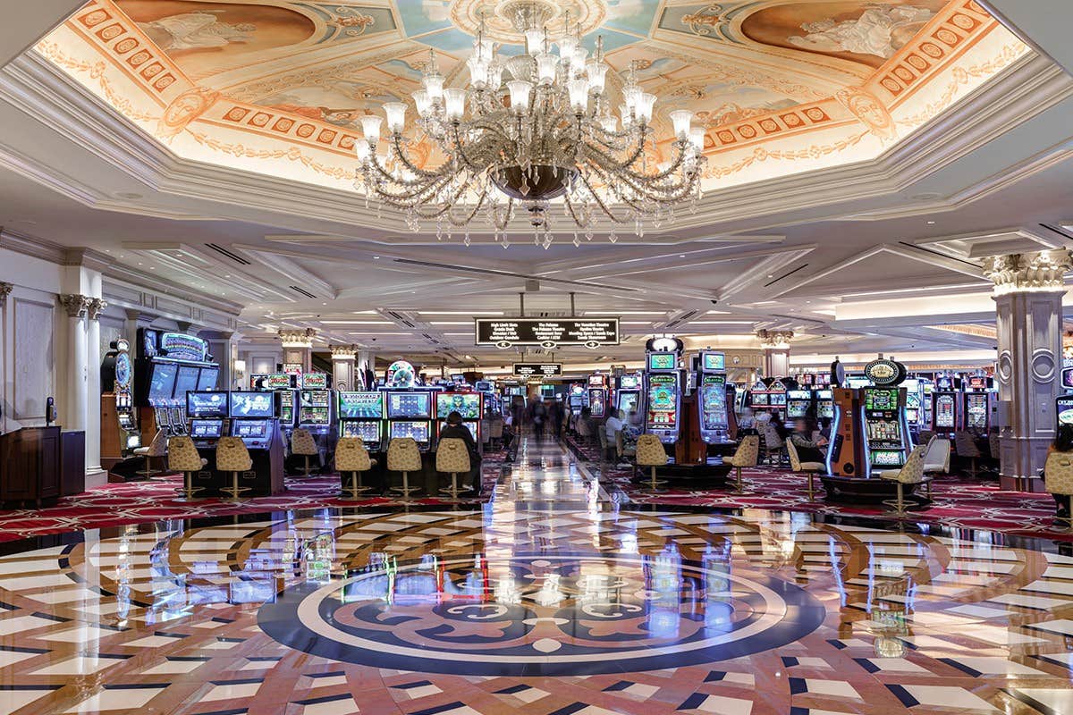 Interior of the casino with slot machines, a chandelier and bright lights