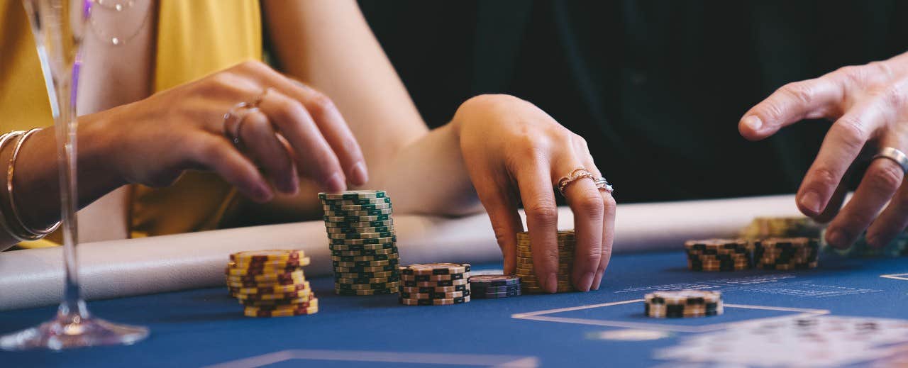 A women bidding poker chips while playing a table game