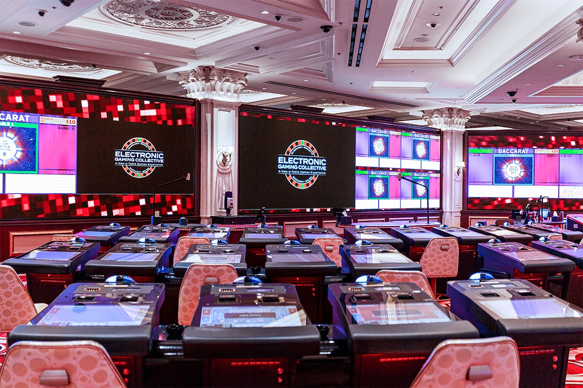 An expansive set of LED screens in an electronic table games room