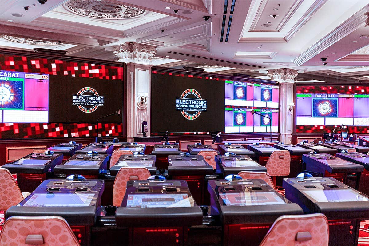 An expansive set of LED screens in an electronic table games room