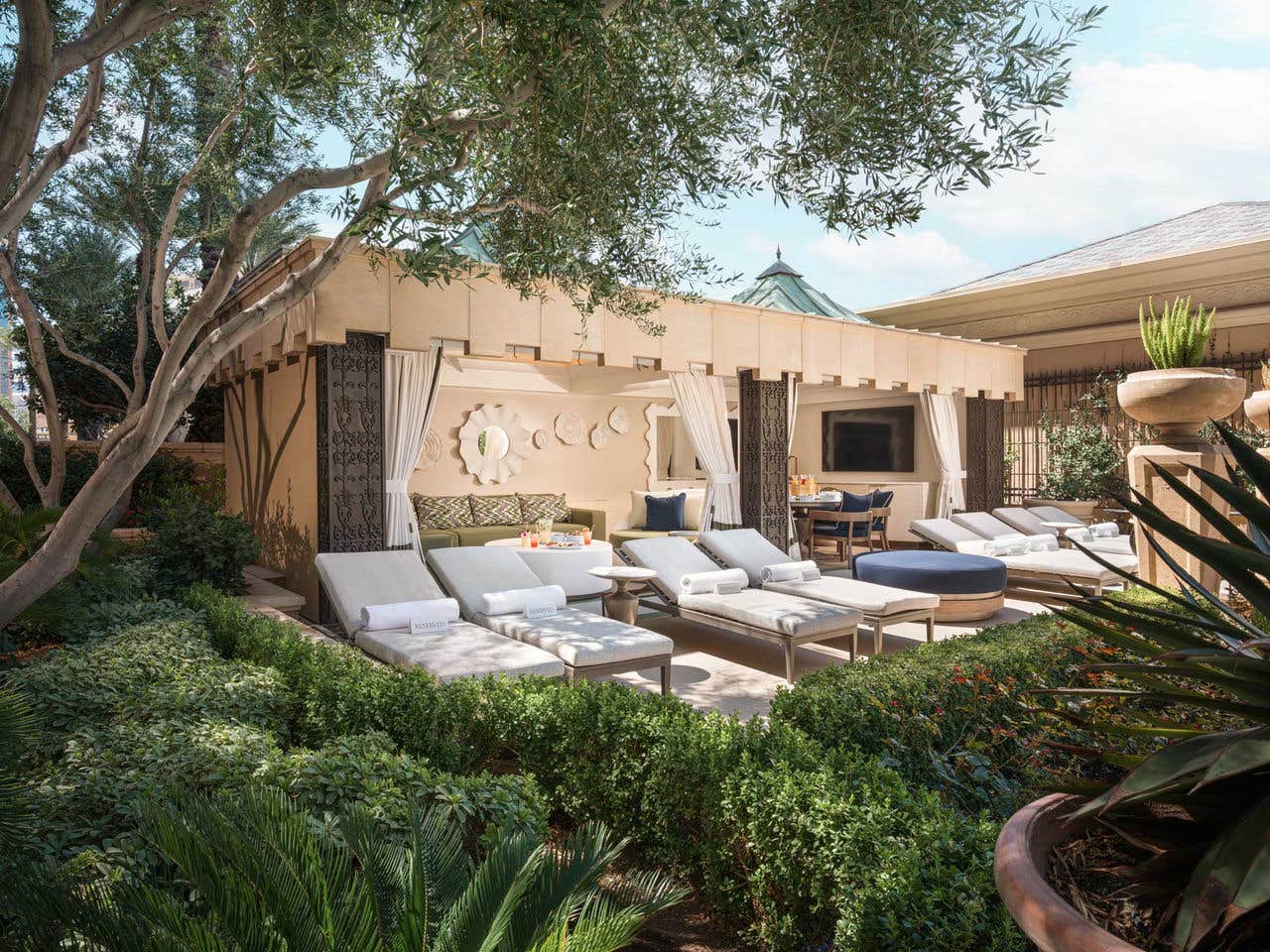 Super Cabana at The Palazzo Pool Deck amongst green bushes, trees, and plants