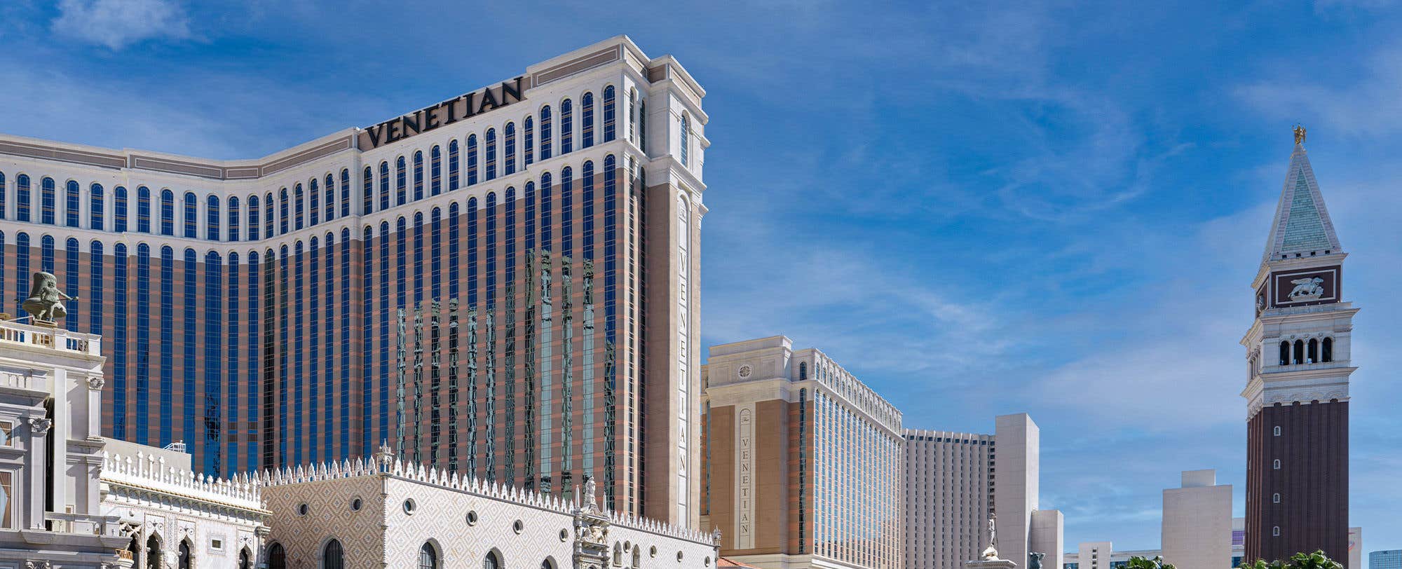 An exterior daytime view of The Venetian North and South towers on the left along with The Campanille Tower on the right 