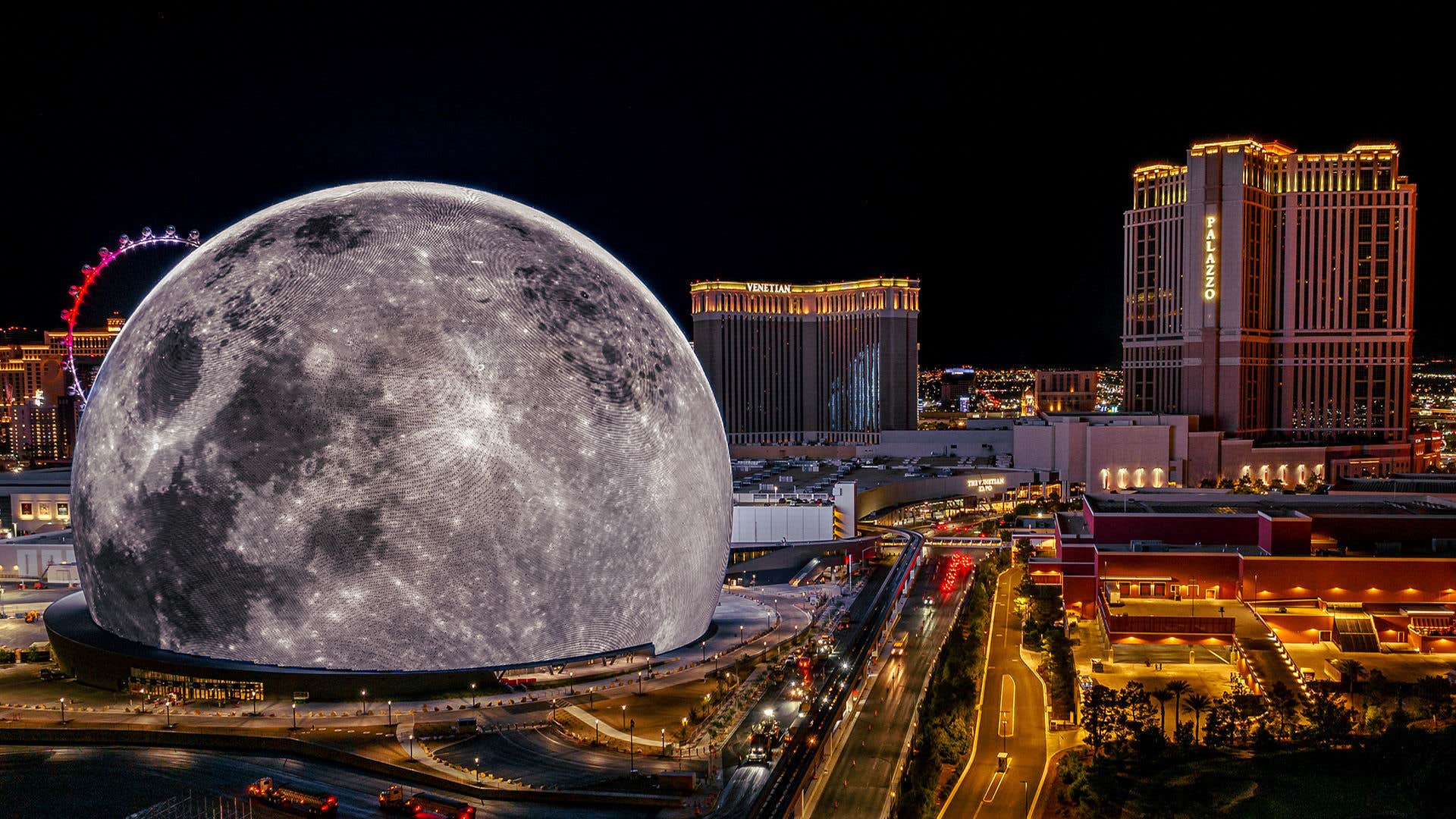 aerial view of the Las Vegas skyline at night, with the Sphere at The Venetian in the foreground showing the moon on display, with The Venetian Resort in the background