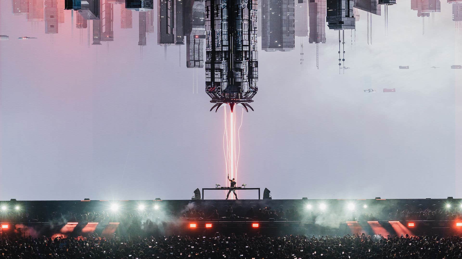 Futuristic cityscape with mirrored buildings, a central tower emitting light beams, and a stage with a DJ and crowd below.