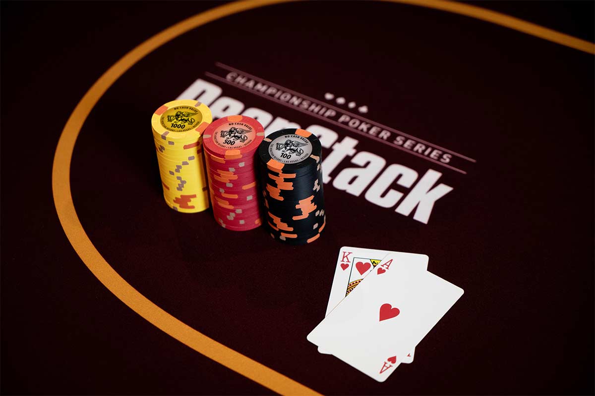 A King and Ace next to a stack of chips on a DeepStack poker table