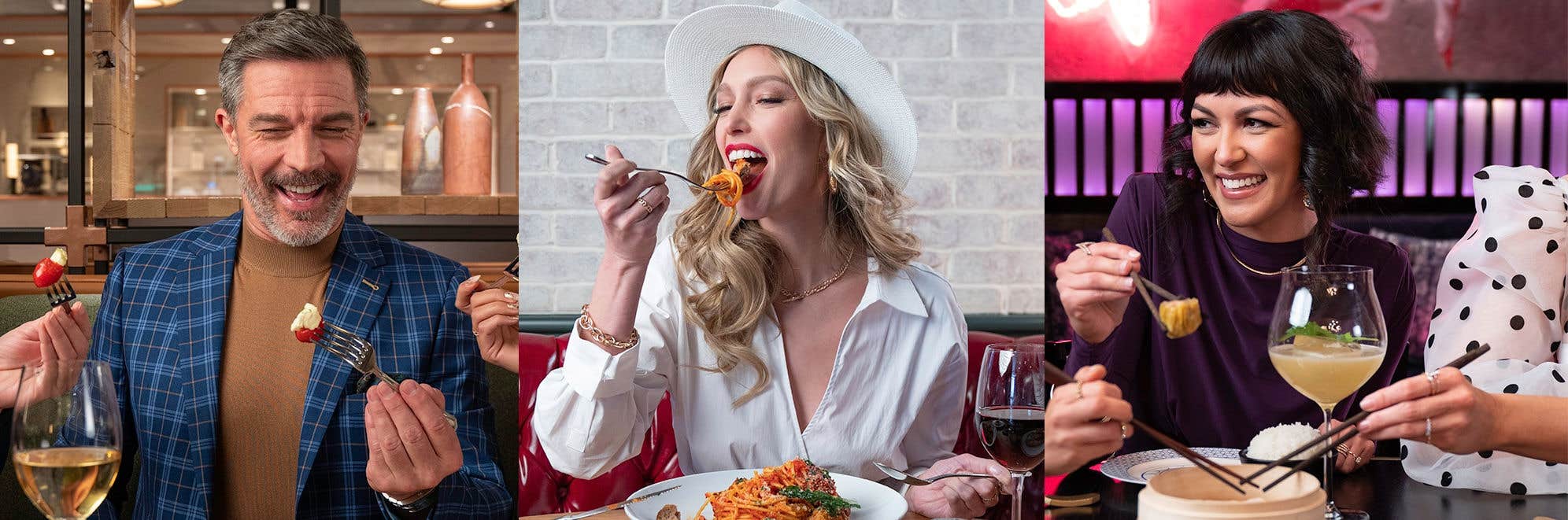 Three people enjoying different meals: one with a salad, one with pasta, and one with dumplings. Each has a drink nearby.