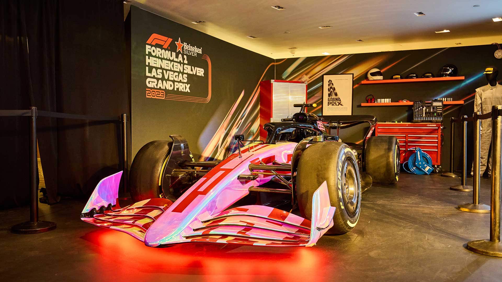 Displayed Formula 1 car with vibrant lights in a garage setting, promoting the Las Vegas Grand Prix in 2023.