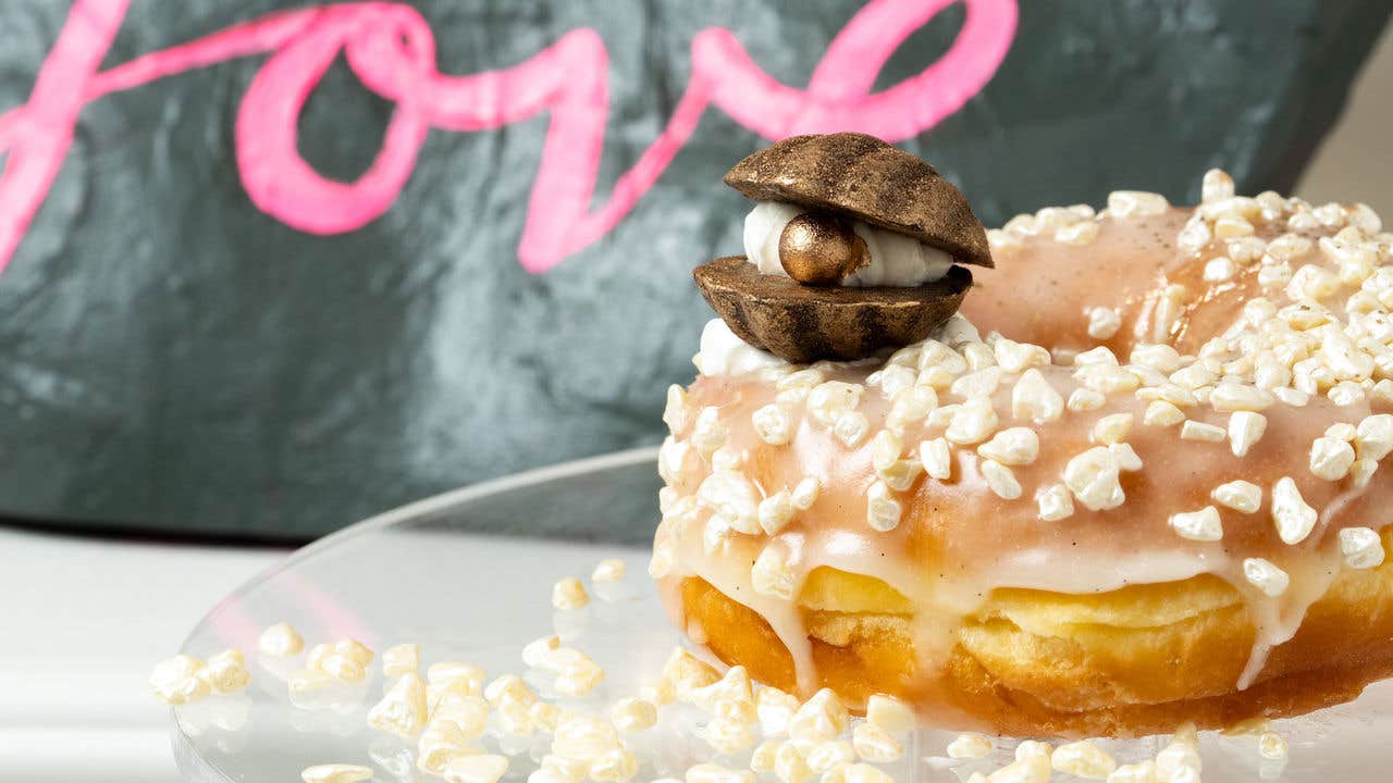 Donut with large sprinkles and a candy oyster with a pearl