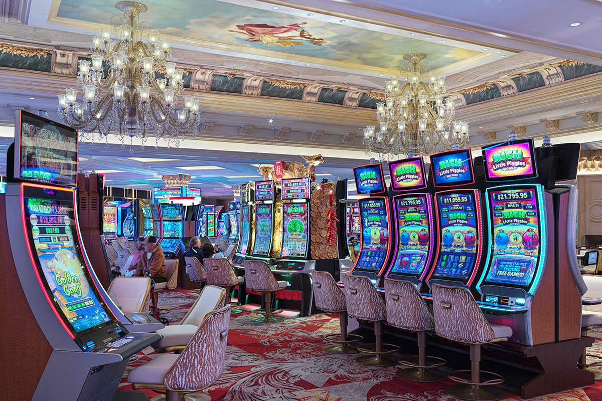 Slot machines under chandeliers and a fresco ceiling at The Venetian Resort Las Vegas