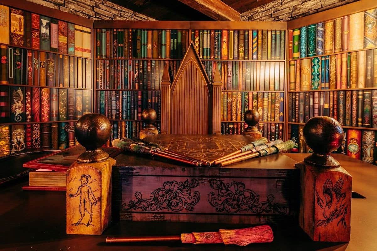 A library with a large table covered in wizard tools