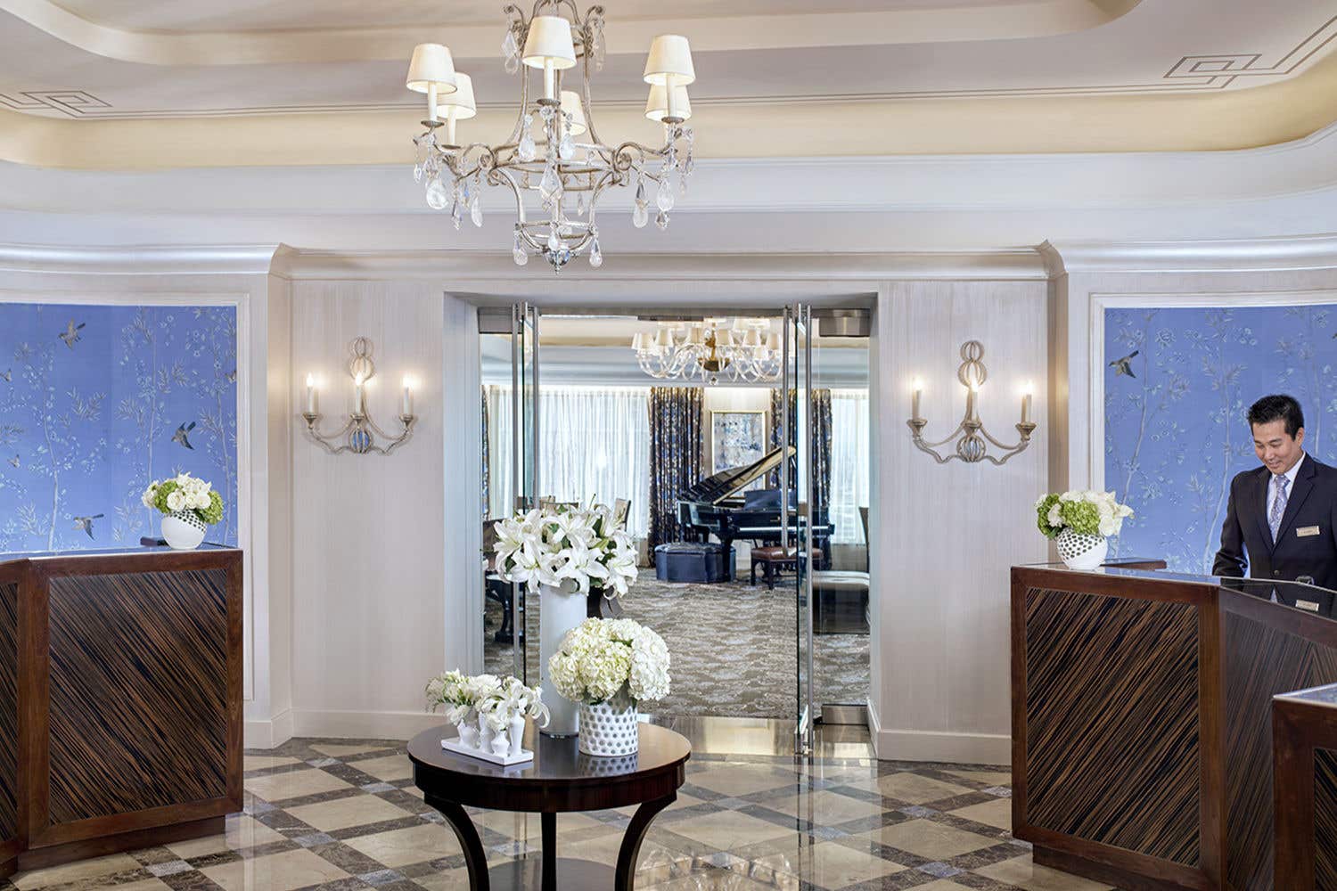 Outside a room looking into a room with a piano and lounge area.