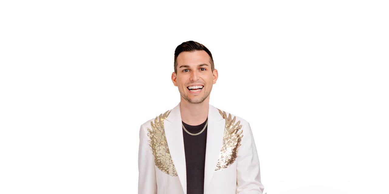 Matt Fraser wearing a white suit jacket with wings.