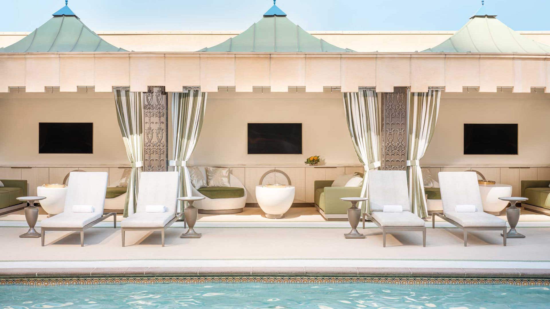 Cabanas at The Palazzo Pool Deck featuring a seating area, table, and television