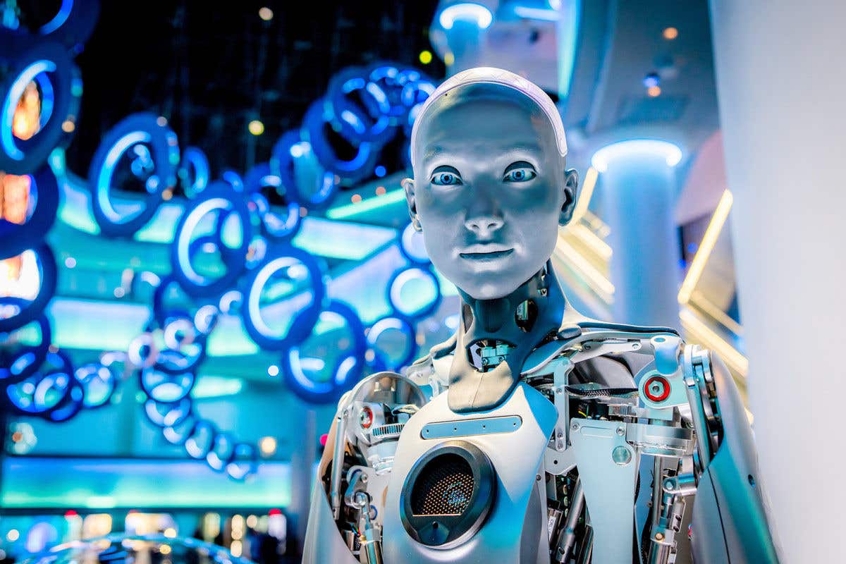 A silver humanoid robot in a futuristic setting with glowing blue circles in the background.