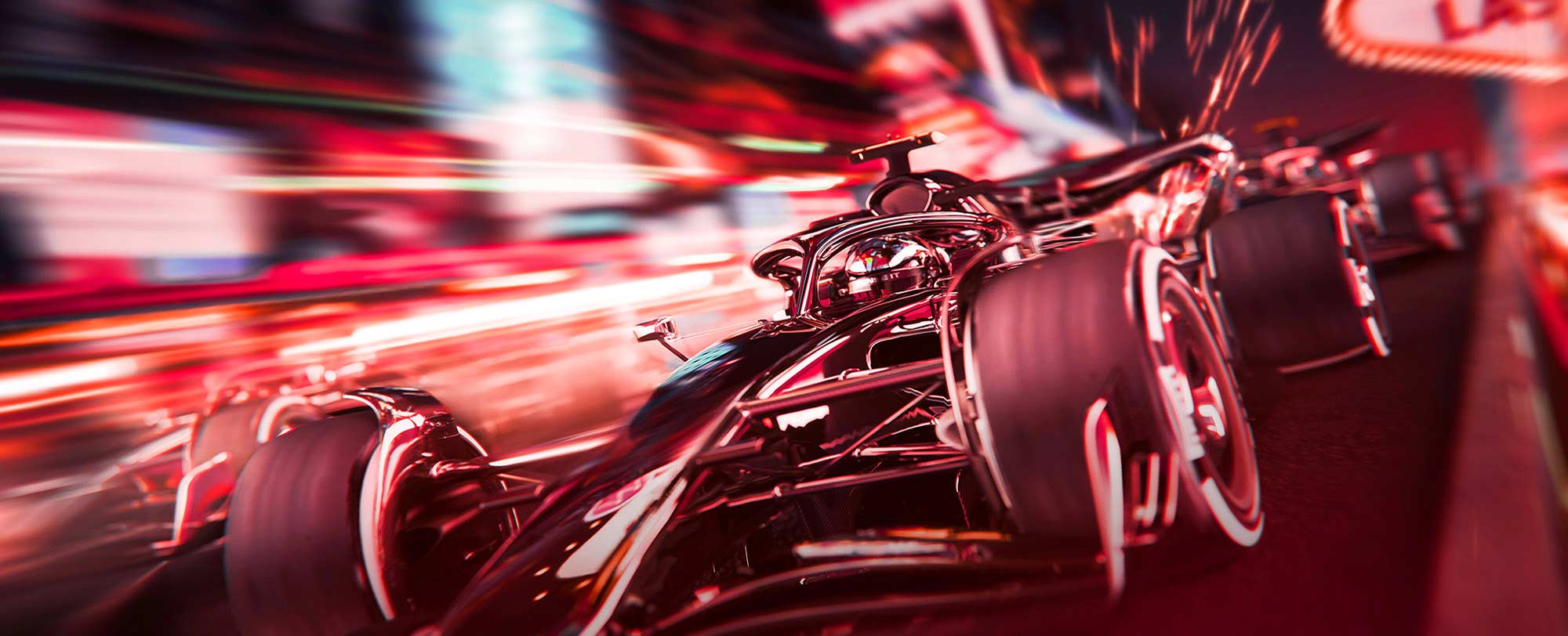 Close-up of a Formula 1 race car speeding on a brightly lit track, with another car closely behind in motion blur.