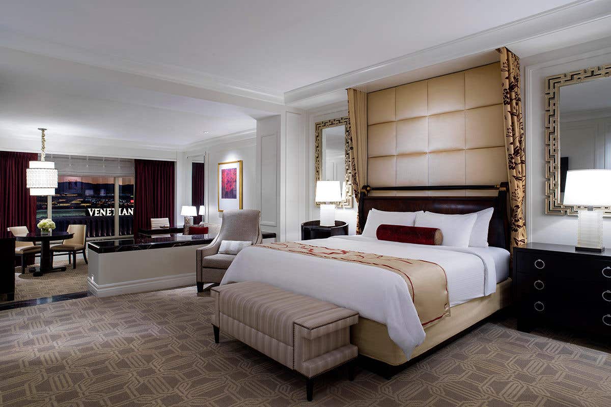 A Luxury King Suite in The Palazzo with a night view of The Venetian