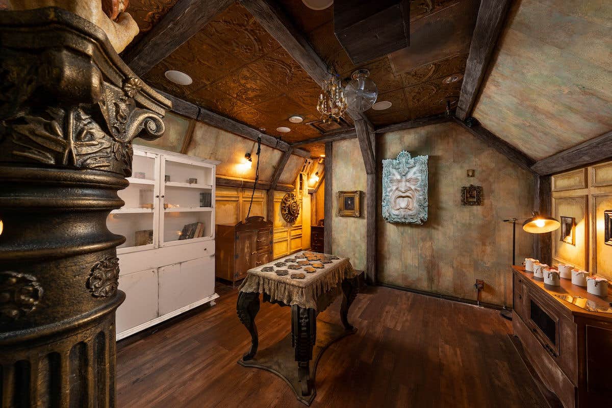 A rustic room with a wooden table and various small objects.