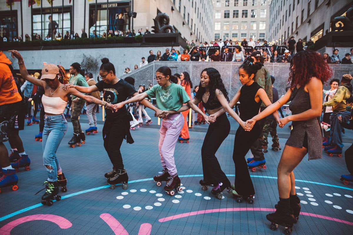 People skating inside Flippers link while holding each other's hands.