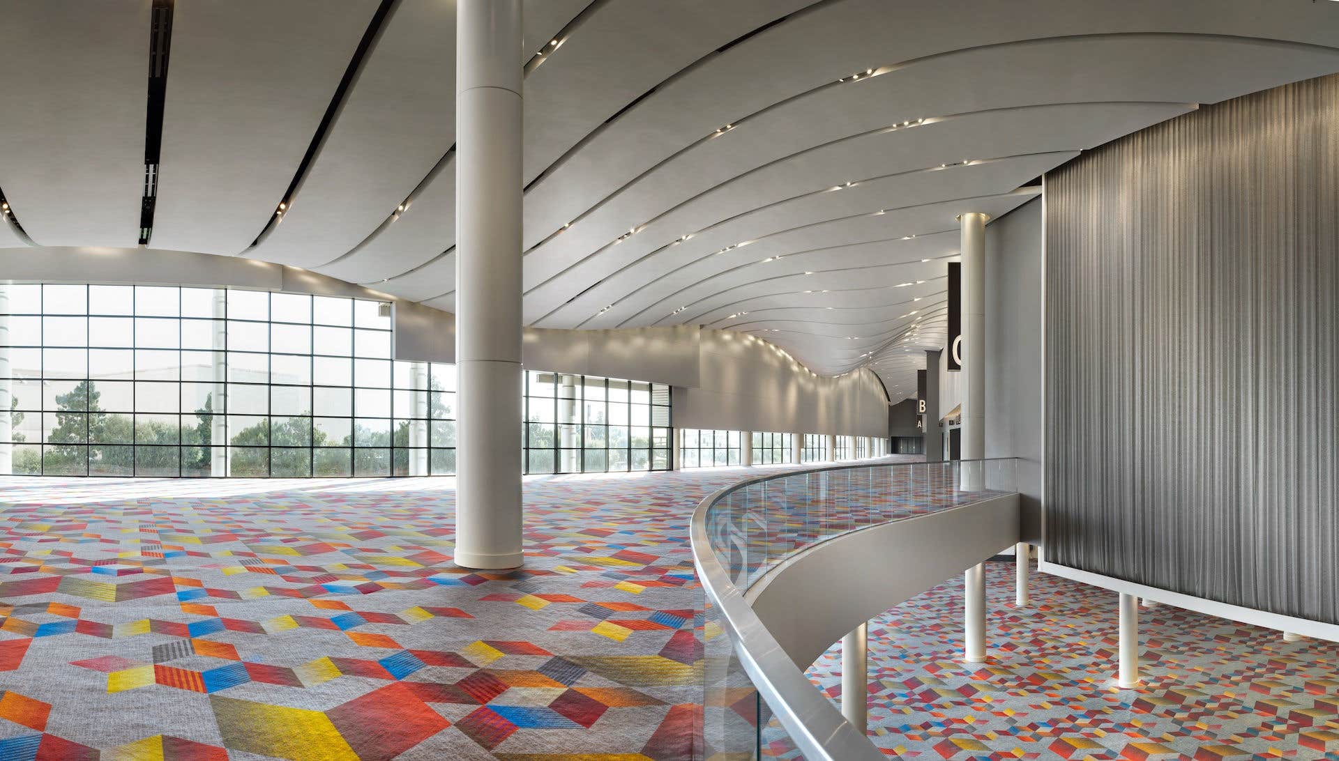 A bright empty venetian exp lobby with a red, blue, yellow geometric pattern floor. 