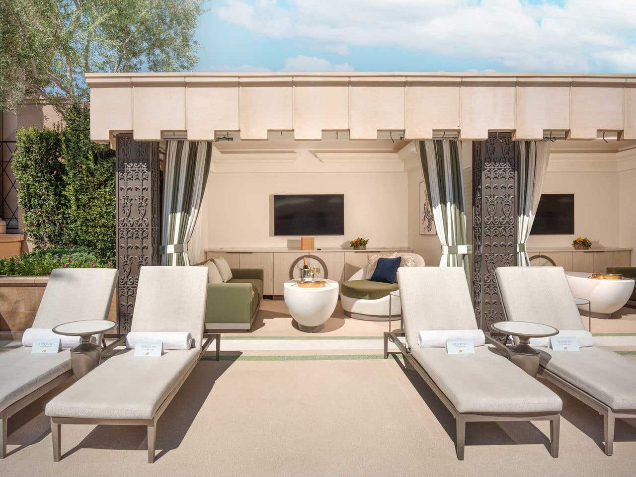 Cabana at The Palazzo Pool Deck featuring a seating area, table, and television