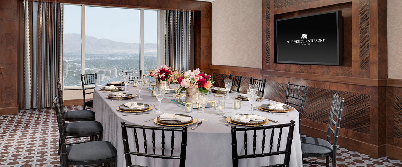 A room plated for 12 people with a view of the mountains. 